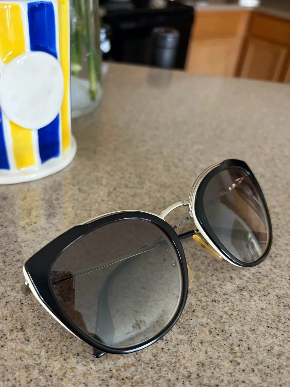 Prada Black and Gold Cat-Eye Sunglasses with Gradient Lenses